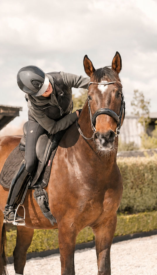 Nicola leaning forward to pat her horse Barney