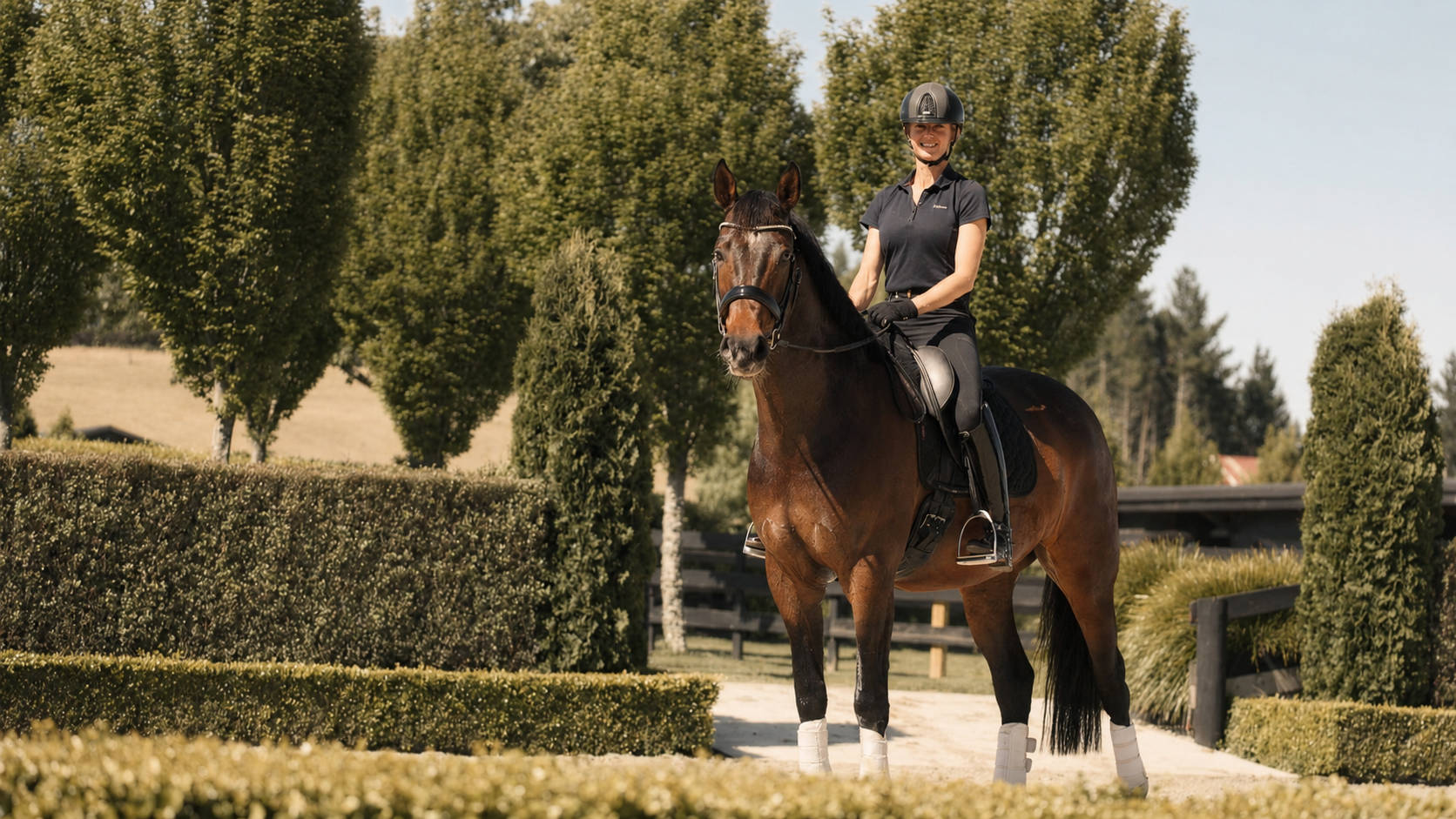 Nicola riding Barney along a hedge-lined path